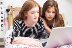 Teenage Girl With Friend Being Bullied On Line