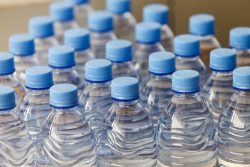 the texture of the necks of plastic bottles of water closeup
