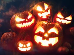 Halloween pumpkin head jack lantern with burning candles in scary deep night forest